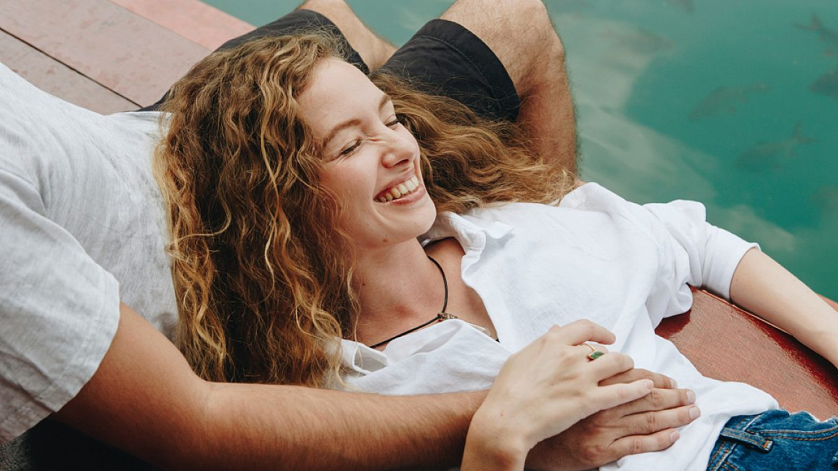 Young couple lying by the pool