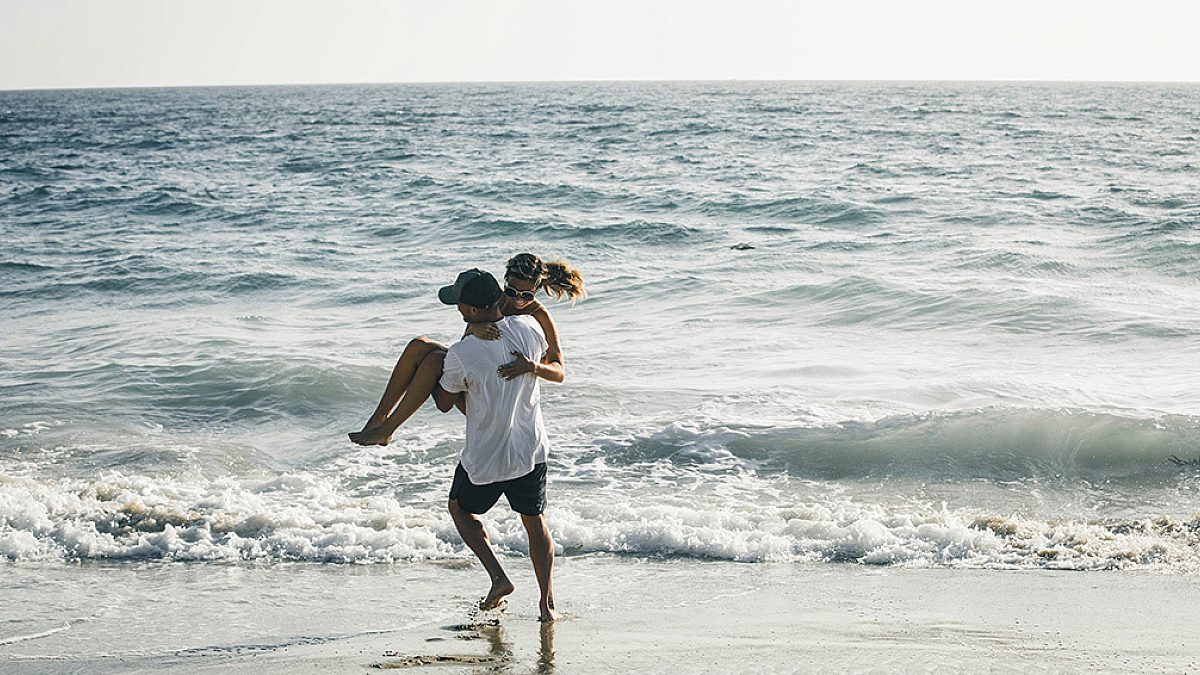 Young couple having fun on the beach